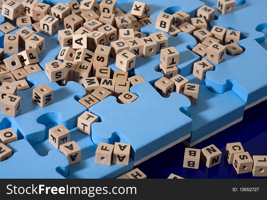 Blue puzzle with  wood letter