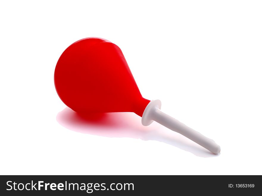 Red rubber enema on a white background