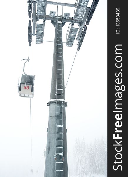 Steel ski lift pylon, cold misty winter day