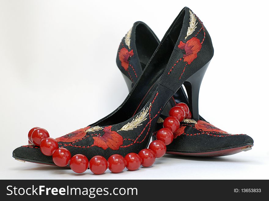 Stylish black and red shoes with coral necklace. Stylish black and red shoes with coral necklace