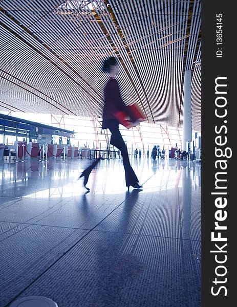 One woman hurrying in airport.