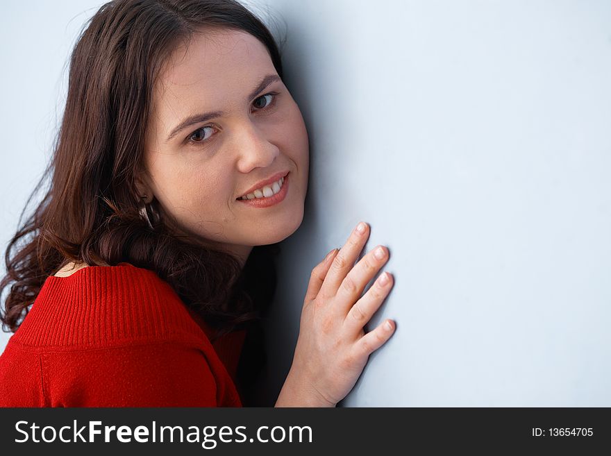 Closeup of a young beautiful woman posing and leaning on the wall. Closeup of a young beautiful woman posing and leaning on the wall