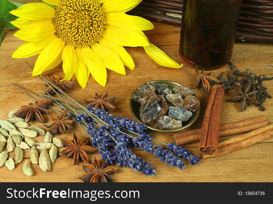 Sunflower and dried aromatic spices on wooden board. Sunflower and dried aromatic spices on wooden board