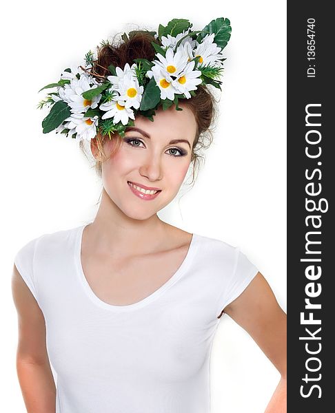 Young beautiful woman in floral wreath over white