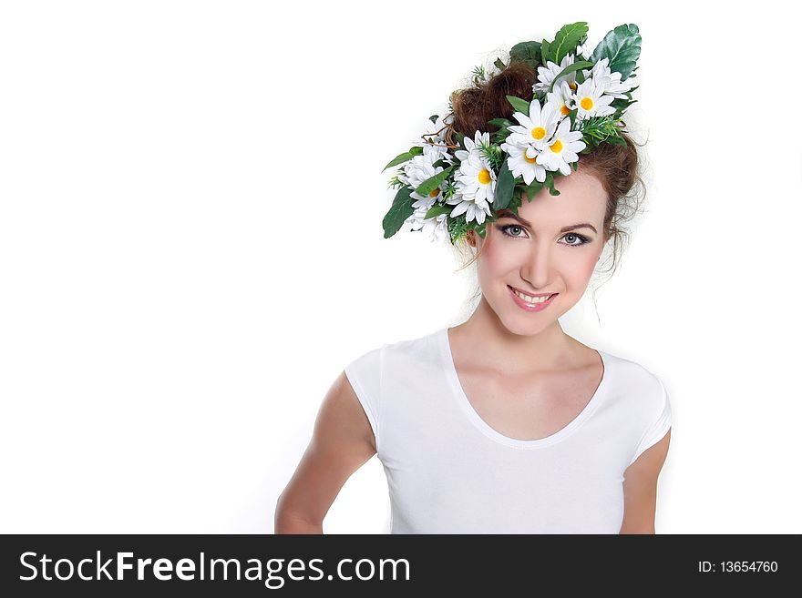 Young beautiful woman in floral wreath over white