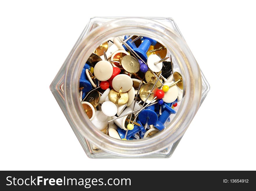 Glass jar with colored Pushpins on white background