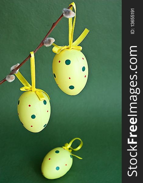 Yellow Easter eggs on green background