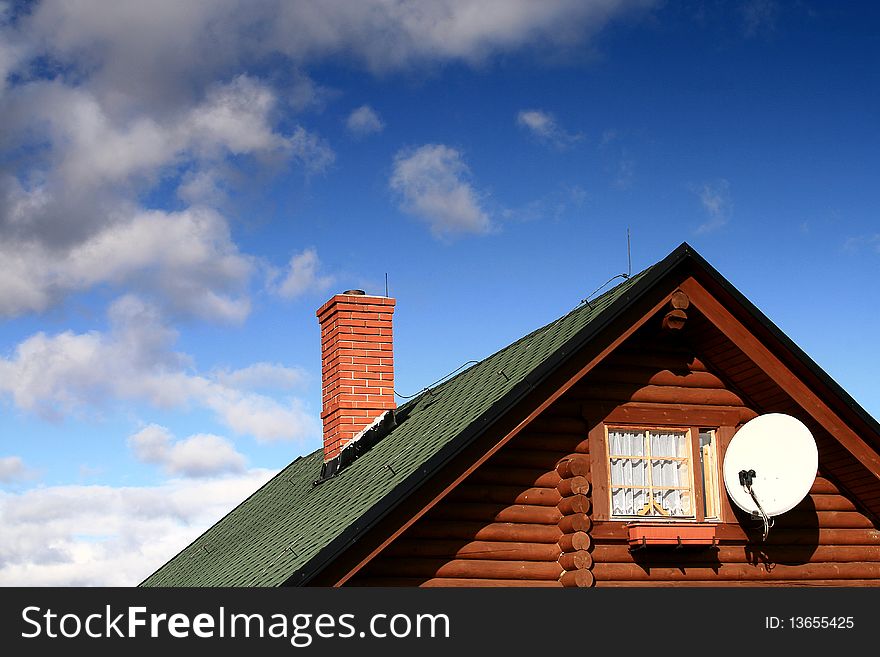 Wooden chalet in blue sky with clouds