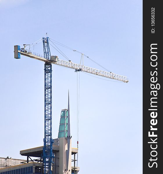 A Tall Blue Tower Crane in the skyline. A Tall Blue Tower Crane in the skyline