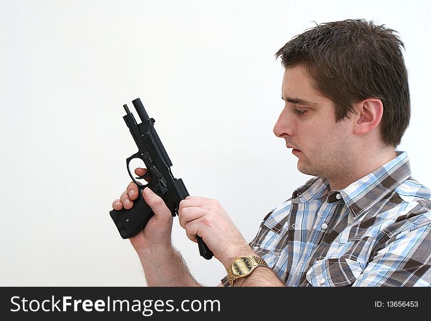 A man chambering a round in his semi auto pistol. A man chambering a round in his semi auto pistol