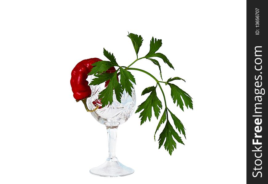 Still-life a crystal glass, pepper and parsley on a white background close up is isolated