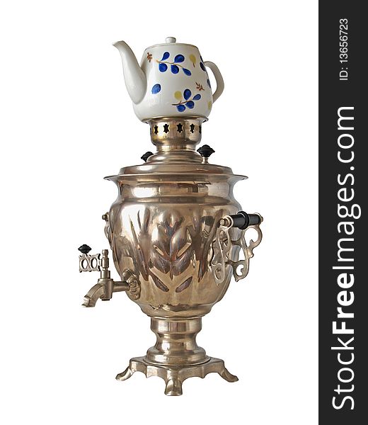 The big silvery Russian samovar for tea preparation and the teapot on a white background close up is isolated. The big silvery Russian samovar for tea preparation and the teapot on a white background close up is isolated