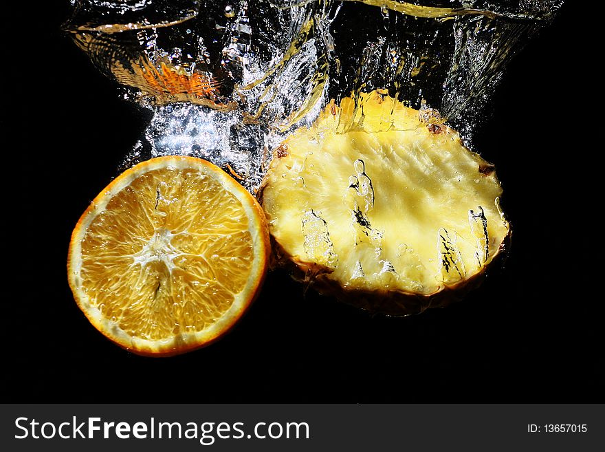Succulent pineapple and orange in water. Succulent pineapple and orange in water