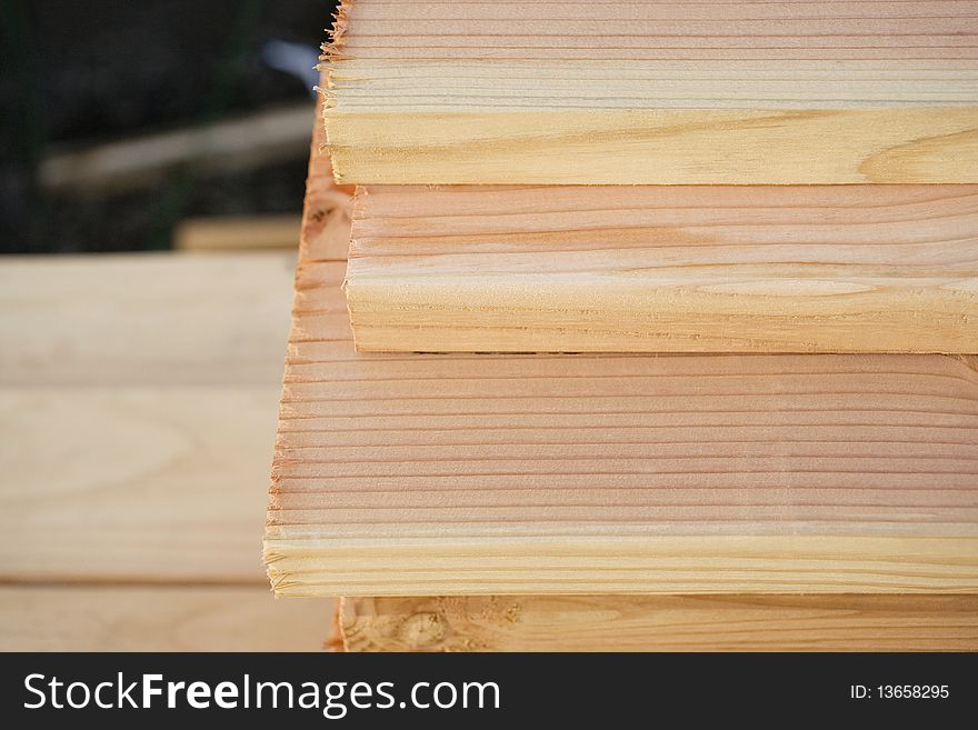 Close up of the end of a stack of cut wooden boards, Horizontal shot. Close up of the end of a stack of cut wooden boards, Horizontal shot.