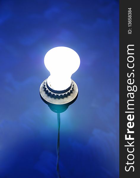 Bright bulb on a dark blue background. Bright bulb on a dark blue background