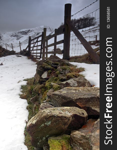 A traditional stone wall and fence in a wintery Lake District, Cumbria