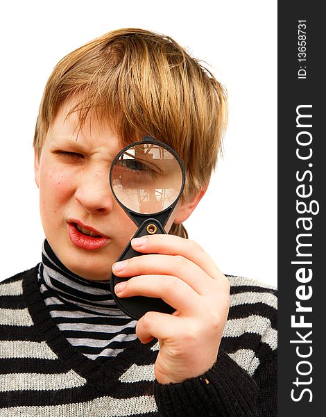 A boy looking through a magnifying glass on a white background. A boy looking through a magnifying glass on a white background