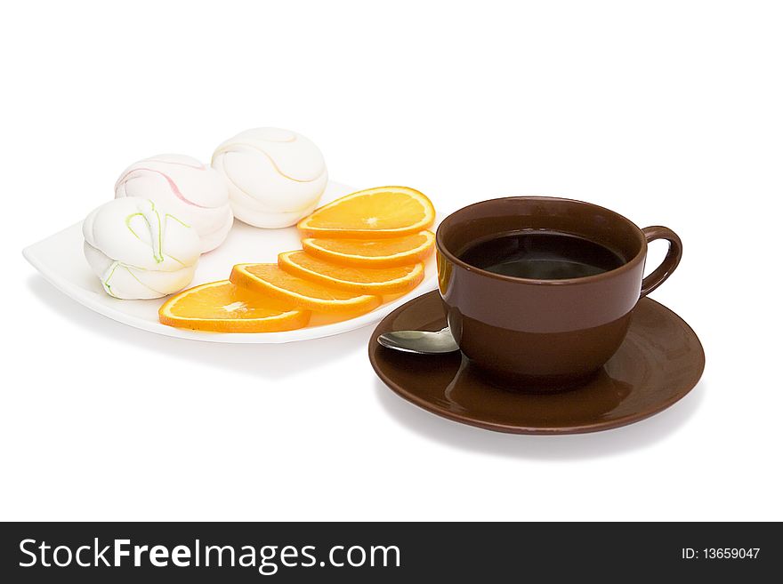 Cup of coffee, a sweet zephyr and oranges in a plate on a white background. Cup of coffee, a sweet zephyr and oranges in a plate on a white background