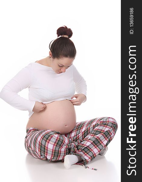 Pregnant woman looking belly on white background