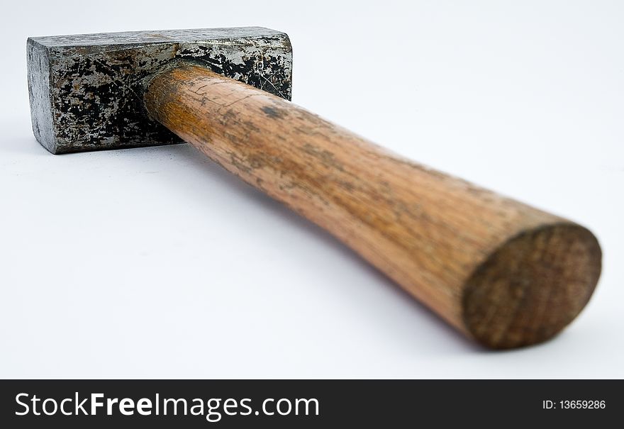 Big hammer with wooden grip on white underground