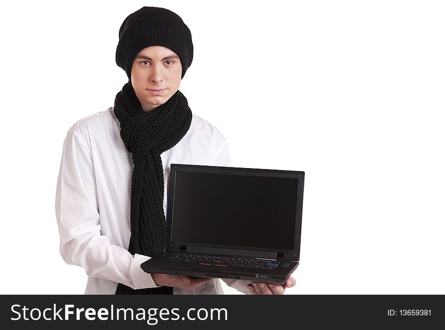 Teenager with a knitted cap and scarf, holding a laptop. Teenager with a knitted cap and scarf, holding a laptop.