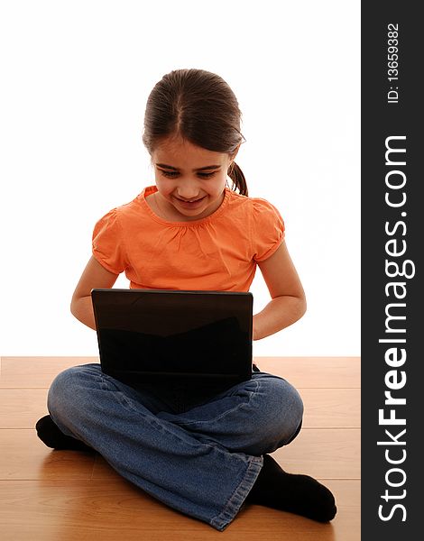 Young child looking happy using laptop computer. Young child looking happy using laptop computer
