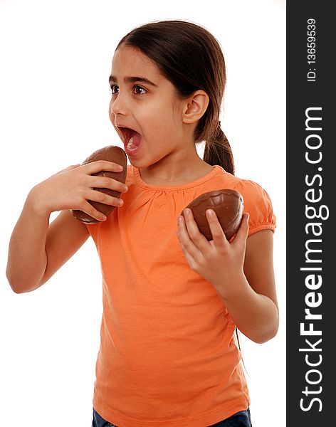 Girl eating Easter egg treat isolated on white