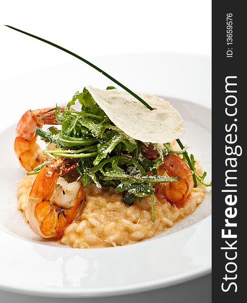 Risotto with Tiger Prawns and Rucola. Served with Parmesan Chip. Risotto with Tiger Prawns and Rucola. Served with Parmesan Chip