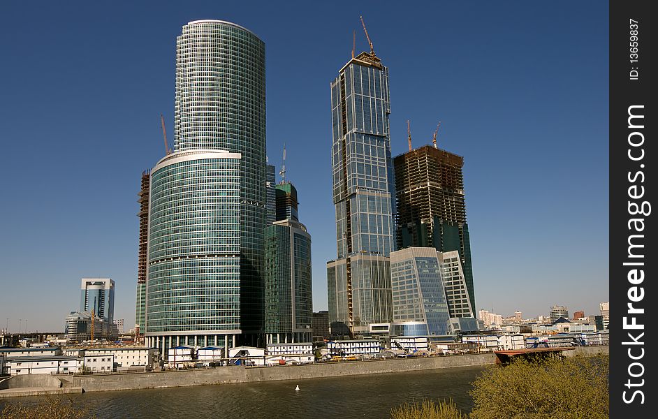 Blue modern office buildings over blue sky
