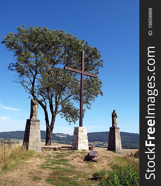 Cross on the hill with statues of Saint Peter and Saint Paul, Bohemian Paradise, Czech Republic, Europe.