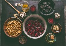 Diced Beet And Salad Ingredients With Pine Nuts, Chickpeas And Prunes On Dark Background, Top View With Copy Space For Your Design Stock Photo
