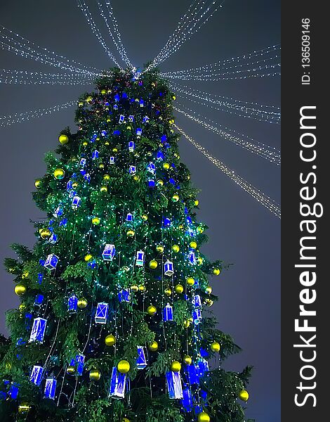 Christmas tree decorated with lanterns outdoors at night. Christmas tree decorated with lanterns outdoors at night