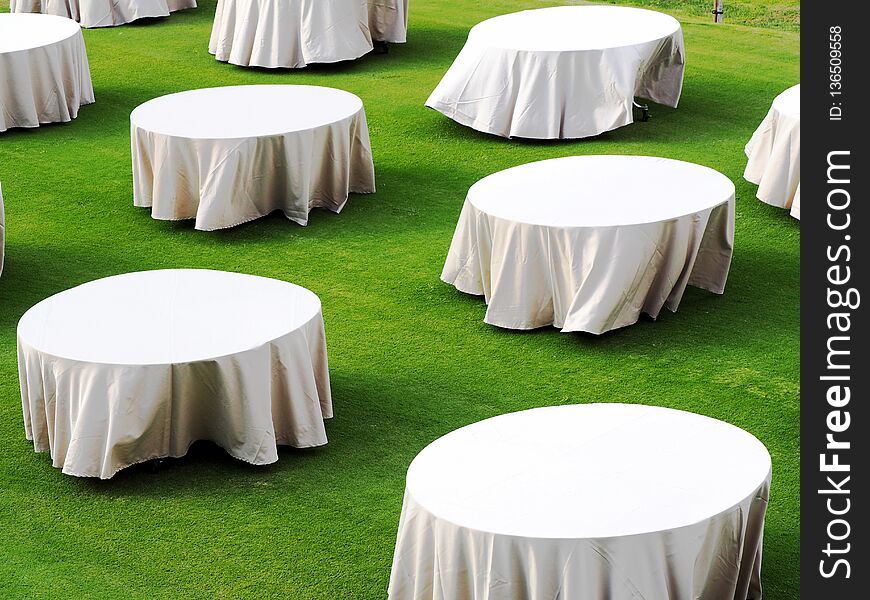 White Round table on green filed in Thailand