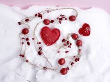 Red Wooden Beads, Felt Handmade Hearts On The Snow, Top View, Concept Of Congratulations On Valentine`s Day Royalty Free Stock Image
