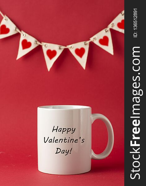 Cup with Happy Valentine&#x27;s Day inscription, words for Valentines Day on red background. Love celebration