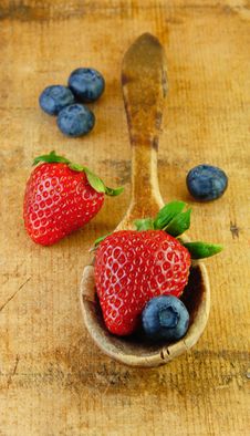 Fresh Strawberries And Blueberries In Wooden Spoon Royalty Free Stock Image