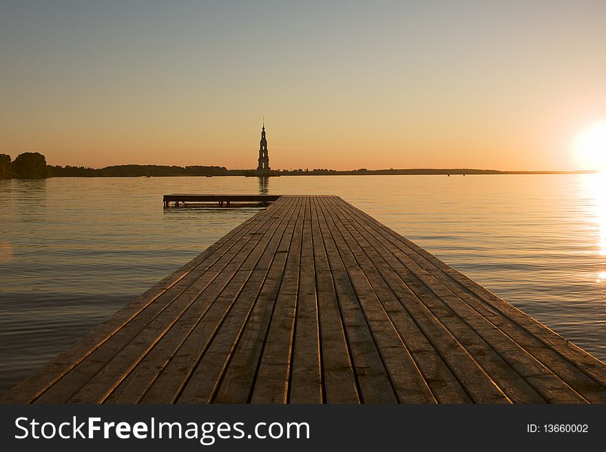 Sunset over Volga river, wooden quay at foreground. Sunset over Volga river, wooden quay at foreground