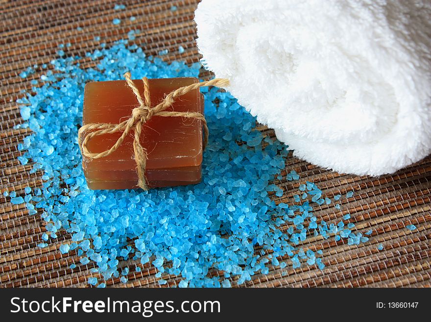 Spa concept. Sea salt on natural bamboo background.