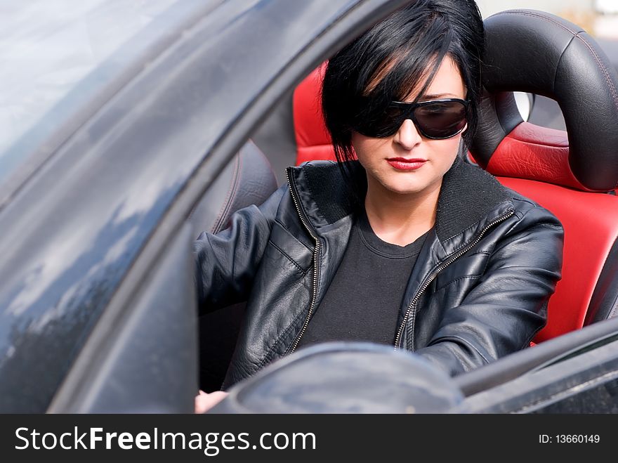 Young attractive woman in a black cabriolet. Young attractive woman in a black cabriolet.