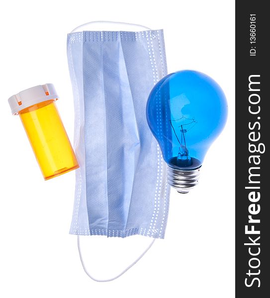 Prescription bottle, surgical mask and light bulb suggest ideas about health care and medicine. Prescription bottle, surgical mask and light bulb suggest ideas about health care and medicine.