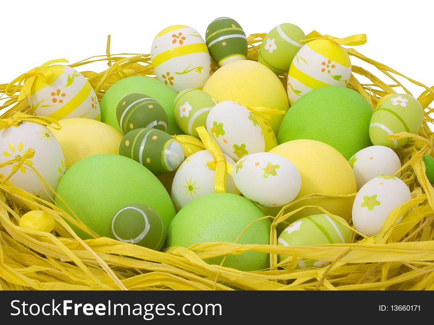 Colorful painted Easter eggs in the nest isolated on white background with clipping path