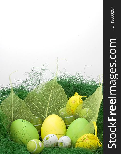 Colorful painted Easter eggs on green grass isolated on white background with copy past space