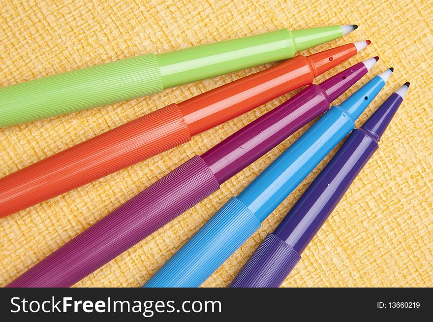 Vibrant Pens On Yellow Background
