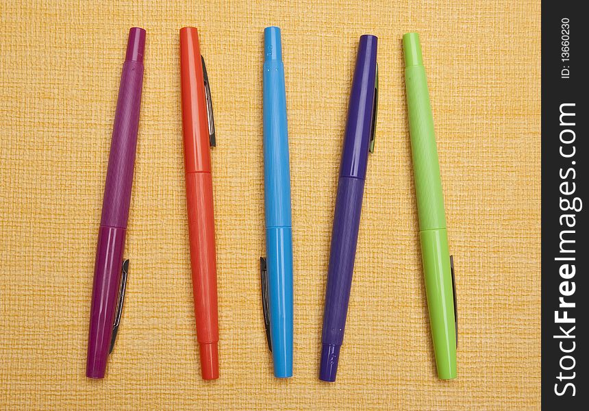 Vibrant Pens On Yellow Background
