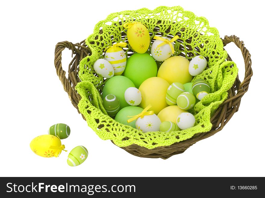 Colorful painted Easter eggs in the basket isolated on white background with clipping path