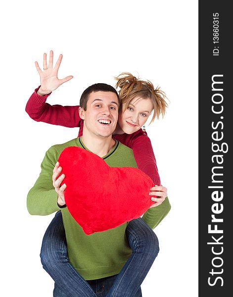 Young loving couple smiling with heart in hands looking at camera, beautiful woman sitting on handsome man