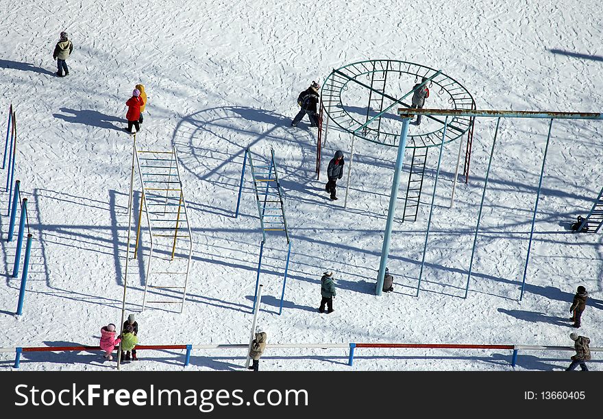 Children playground on winter day, top view, shadow