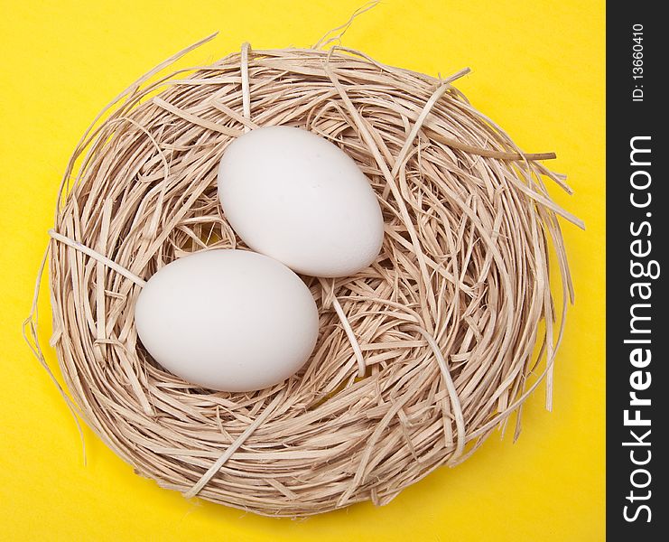Eggs in a Nest on a Yellow Background.
