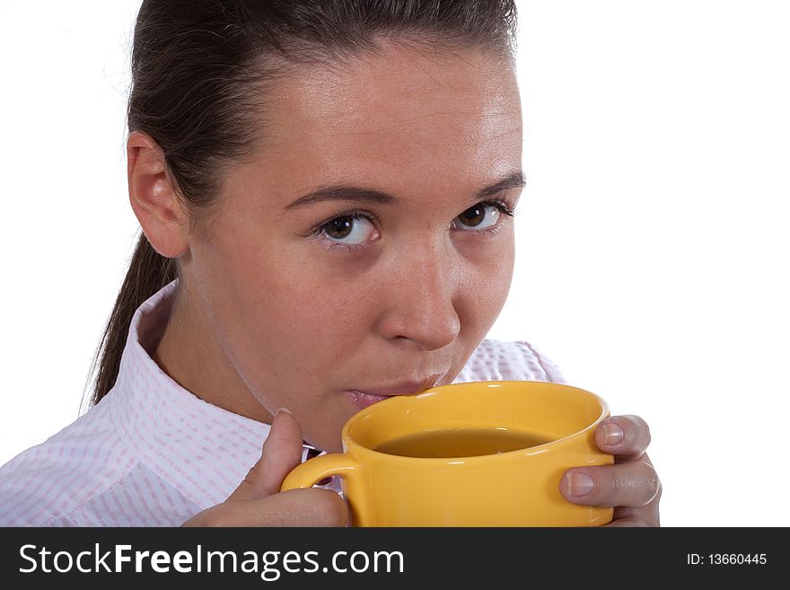 Young beautyful woman drink tea from big yellow cap. Young beautyful woman drink tea from big yellow cap