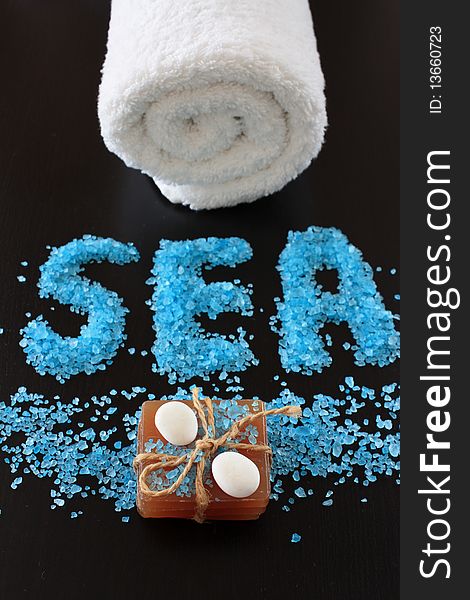 Spa concept. Sea salt on dark background.